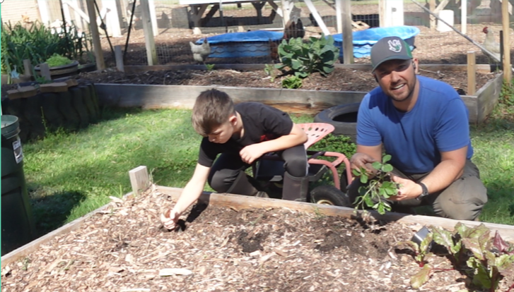 Layering wood chips in our strawberry patch to follow gardening God's way